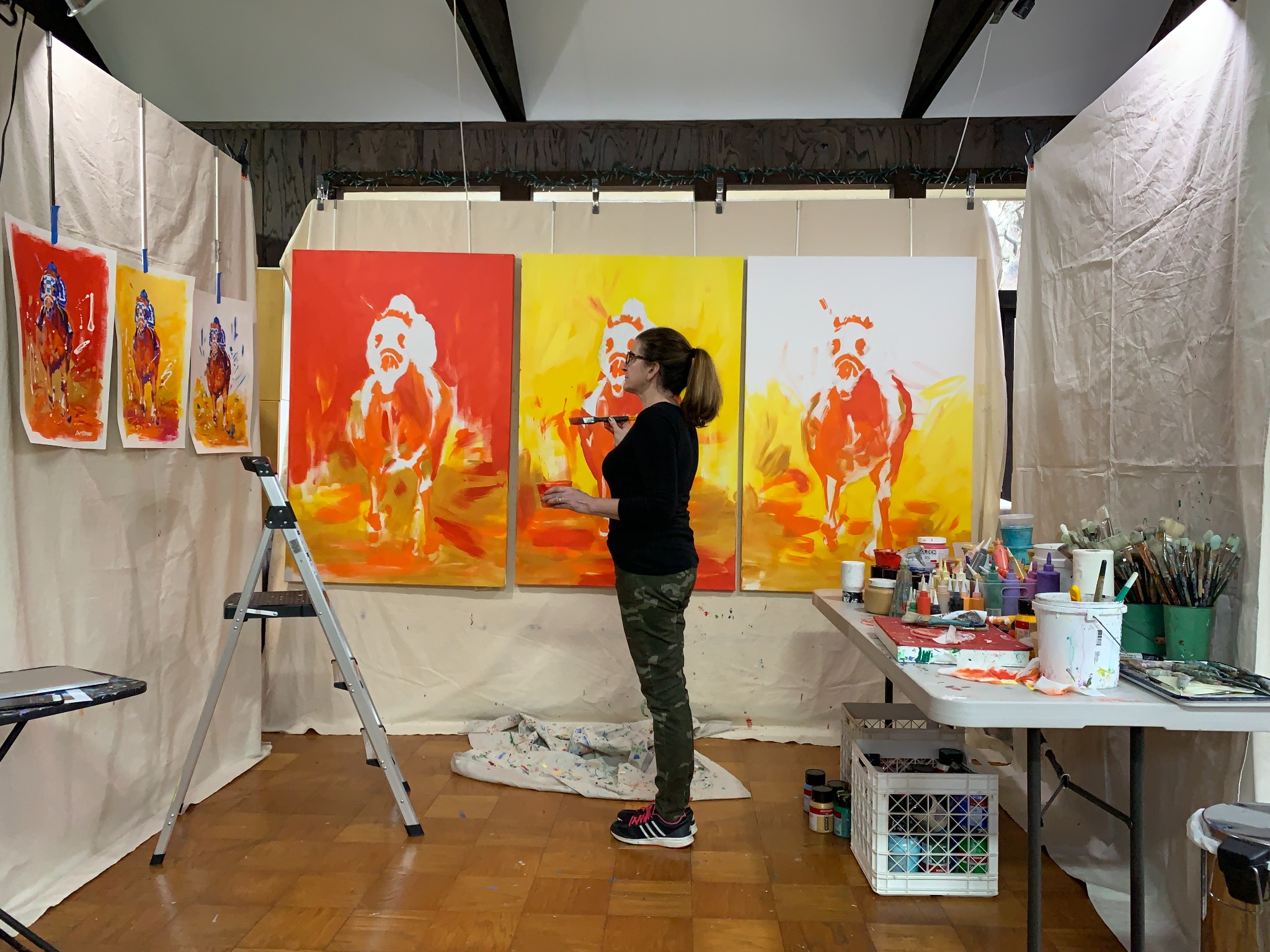 Lisa Palombo painting equine canvases in her Caldwell studio